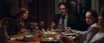 Movie still from “Clouds” (2020), directed by Justin Baldoni – A man sitting at a dinner table with food on the table; Medium shot, Over the shoulder angle