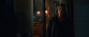 Movie still from “Clouds” (2020), directed by Justin Baldoni – A woman standing in front of a window in a dark room; Medium shot, Over the shoulder angle