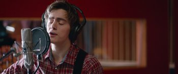 Movie still from “Clouds” (2020), directed by Justin Baldoni – A young man wearing headphones while listening to music; Close Up shot, Low angle