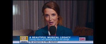 Movie still from “Clouds” (2020), directed by Justin Baldoni – A woman is talking into a microphone on tv; Close Up shot, Over the shoulder angle