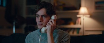 Movie still from “Clouds” (2020), directed by Justin Baldoni – A man holding a phone up to his ear; Close Up shot, Over the shoulder angle