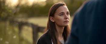 Movie still from “Clouds” (2020), directed by Justin Baldoni – A young woman with long brown hair looking to her left; Close Up shot, Over the shoulder angle
