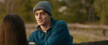 Movie still from “Clouds” (2020), directed by Justin Baldoni – A young man wearing a hat and a blue jacket; Close Up shot, Over the shoulder angle
