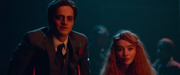 Movie still from “Clouds” (2020), directed by Justin Baldoni – A man and a woman standing next to each other in a dark room; Medium shot, Low angle