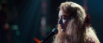 Movie still from “Clouds” (2020), directed by Justin Baldoni – A woman with long hair is speaking into a microphone; Close Up shot, Over the shoulder angle