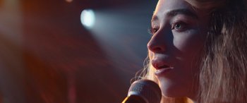 Movie still from “Clouds” (2020), directed by Justin Baldoni – A person holding a microphone; Close Up shot, Over the shoulder angle