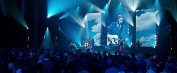Movie still from “Clouds” (2020), directed by Justin Baldoni – A man with a guitar in front of an audience; Wide shot, Over the shoulder angle