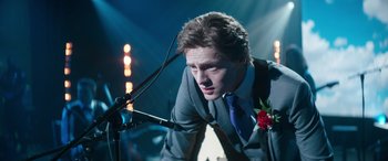 Movie still from “Clouds” (2020), directed by Justin Baldoni – A man in a gray suit and a blue tie; Medium shot, Over the shoulder angle