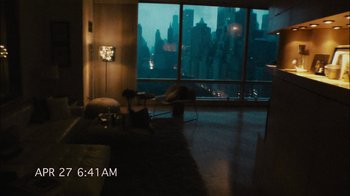 Movie still from “Cloverfield” (2008), directed by Matt Reeves – A living room with a view of a city at night time; Extreme Wide shot, High angle