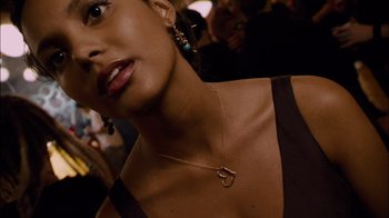 Movie still from “Cloverfield” (2008), directed by Matt Reeves – A person wearing a necklace; Close Up shot, Over the shoulder angle