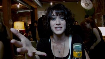 Movie still from “Cloverfield” (2008), directed by Matt Reeves – A young woman is smiling and pointing to the camera; Close Up shot, Over the shoulder angle