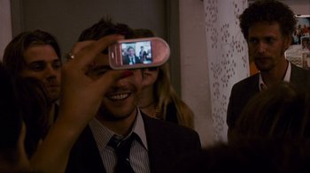 Movie still from “Cloverfield” (2008), directed by Matt Reeves – A man taking a picture with a cell phone; Close Up shot, Over the shoulder angle