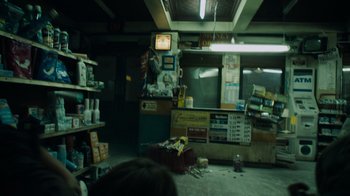 Movie still from “Cloverfield” (2008), directed by Matt Reeves – An empty store room with lots of items on the floor; Wide shot, High angle
