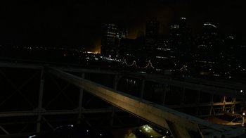 Movie still from “Cloverfield” (2008), directed by Matt Reeves – A view of a city at night from a bridge at night time; Extreme Wide shot, High angle