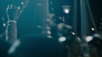 Movie still from “Cloverfield” (2008), directed by Matt Reeves – A blurry picture of a room with a lot of lights; Extreme Close Up shot, Over the shoulder angle