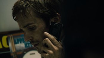 Movie still from “Cloverfield” (2008), directed by Matt Reeves – A person talking on a cell phone; Extreme Close Up shot, Low angle