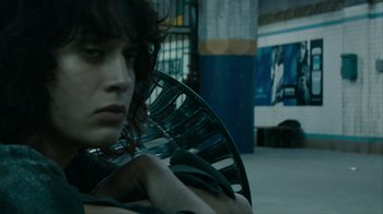 Movie still from “Cloverfield” (2008), directed by Matt Reeves – A person with a fan sitting in a room; Close Up shot, Low angle