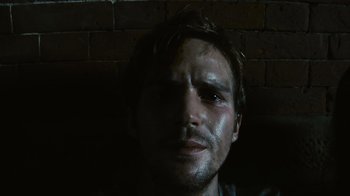 Movie still from “Cloverfield” (2008), directed by Matt Reeves – A person wearing a shirt; Close Up shot, Low angle