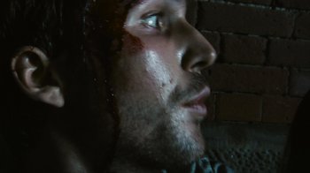 Movie still from “Cloverfield” (2008), directed by Matt Reeves – A person's face with blood on his face; Extreme Close Up shot, Low angle