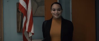 Movie still from “Cobweb” (2023), directed by Samuel Bodin – A woman in an orange shirt and a black jacket; Medium shot, Over the shoulder angle