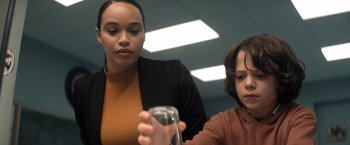 Movie still from “Cobweb” (2023), directed by Samuel Bodin – A woman and a boy looking at a glass; Close Up shot, Over the shoulder angle
