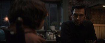 Movie still from “Cobweb” (2023), directed by Samuel Bodin – A man sitting at a table talking to a woman; Close Up shot, Over the shoulder angle