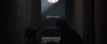 Movie still from “Cobweb” (2023), directed by Samuel Bodin – A man and a boy praying in a dark room; Medium shot, Over the shoulder angle