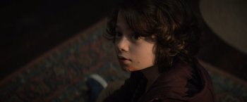 Movie still from “Cobweb” (2023), directed by Samuel Bodin – A young boy is looking into the distance; Close Up shot, High angle