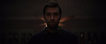 Movie still from “Cobweb” (2023), directed by Samuel Bodin – A person wearing a black shirt; Close Up shot, Low angle