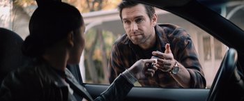 Movie still from “Cobweb” (2023), directed by Samuel Bodin – A man talking to another man in the back of a car; Close Up shot, Over the shoulder angle