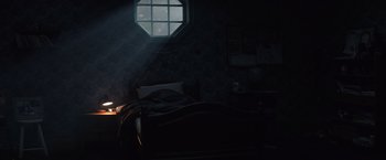 Movie still from “Cobweb” (2023), directed by Samuel Bodin – A bed room with a bed and a window in the dark; Wide shot, High angle