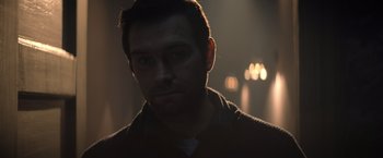 Movie still from “Cobweb” (2023), directed by Samuel Bodin – A person in a dark room; Close Up shot, Low angle