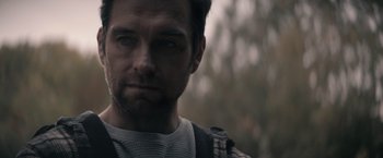 Movie still from “Cobweb” (2023), directed by Samuel Bodin – A person with a beard; Close Up shot, Over the shoulder angle