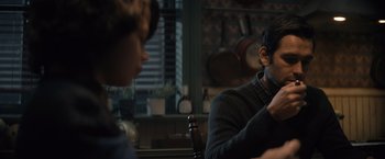 Movie still from “Cobweb” (2023), directed by Samuel Bodin – A man and a woman sitting at a wooden table; Medium shot, Over the shoulder angle