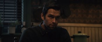 Movie still from “Cobweb” (2023), directed by Samuel Bodin – A person wearing a black shirt; Close Up shot, Over the shoulder angle