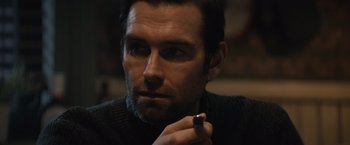 Movie still from “Cobweb” (2023), directed by Samuel Bodin – A person holding a cigarette in his mouth; Close Up shot, Over the shoulder angle