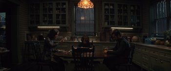 Movie still from “Cobweb” (2023), directed by Samuel Bodin – A group of people sitting at a table in a room; Wide shot, High angle