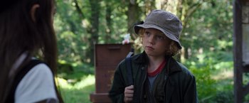 Movie still from “Cocaine Bear” (2023), directed by Elizabeth Banks – A young boy in a hat and a jacket; Close Up shot, Low angle