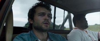 Movie still from “Cocaine Bear” (2023), directed by Elizabeth Banks – A person in a car; Close Up shot, Low angle