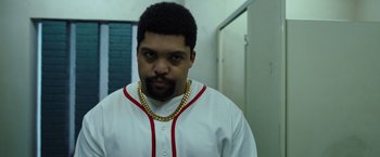 Movie still from “Cocaine Bear” (2023), directed by Elizabeth Banks – A person wearing a baseball uniform; Close Up shot, Low angle