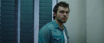 Movie still from “Cocaine Bear” (2023), directed by Elizabeth Banks – A person wearing a jean jacket; Close Up shot, Low angle