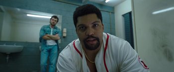 Movie still from “Cocaine Bear” (2023), directed by Elizabeth Banks – A person with a chain around his neck; Close Up shot, Low angle