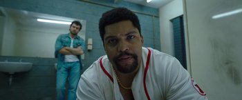 Movie still from “Cocaine Bear” (2023), directed by Elizabeth Banks – A person with a chain around his neck; Close Up shot, Low angle