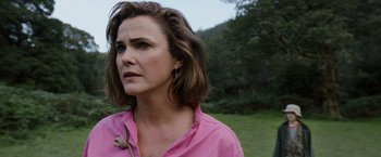Movie still from “Cocaine Bear” (2023), directed by Elizabeth Banks – A person wearing a pink shirt; Close Up shot, Over the shoulder angle