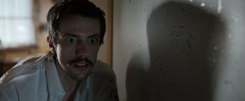 Movie still from “Cocaine Bear” (2023), directed by Elizabeth Banks – A person with a beard; Close Up shot, Low angle