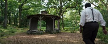 Movie still from “Cocaine Bear” (2023), directed by Elizabeth Banks – An old gazebo in the middle of a forest; Extreme Wide shot, High angle