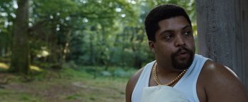 Movie still from “Cocaine Bear” (2023), directed by Elizabeth Banks – A person wearing a chain; Close Up shot, Over the shoulder angle