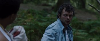 Movie still from “Cocaine Bear” (2023), directed by Elizabeth Banks – A person wearing a jacket; Close Up shot, High angle