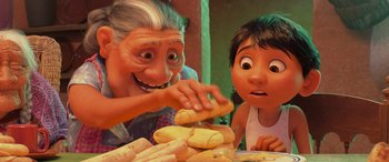 Movie still from “Coco” (2017), directed by Adrian Molina – An old woman and a young boy are eating bananas; Close Up shot, Over the shoulder angle
