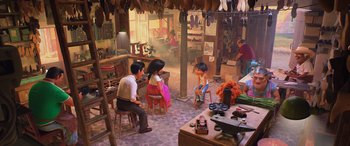 Movie still from “Coco” (2017), directed by Adrian Molina – A group of people sitting around in a room; Wide shot, High angle